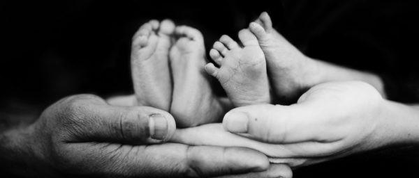 Two sets of Baby Feet with Parents