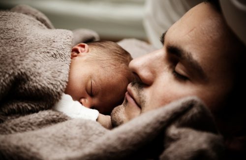 newborn laying on father's chest